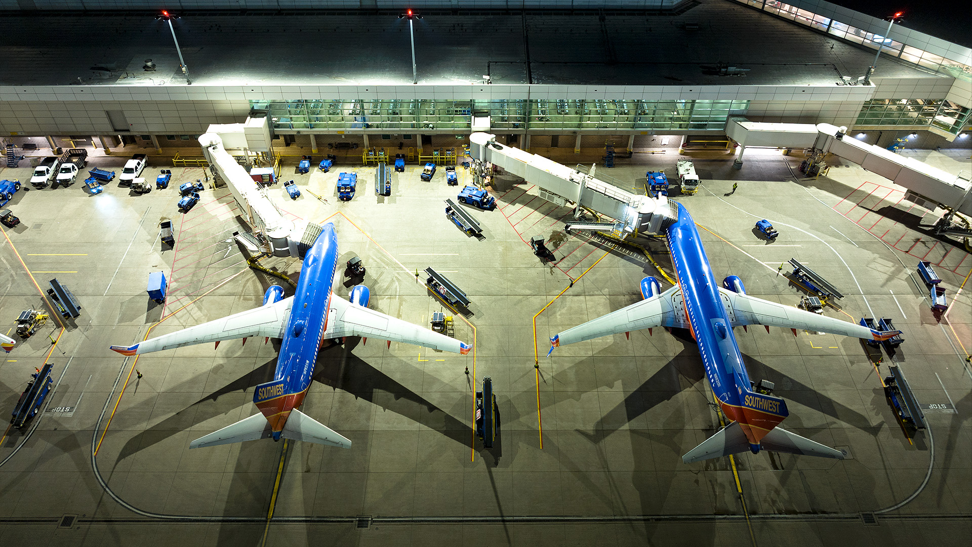 Overhead view of two airplanes parked at Dallas Love Field gate after upgrade to LED airport apron lighting with Musco's TLC for LED technology.