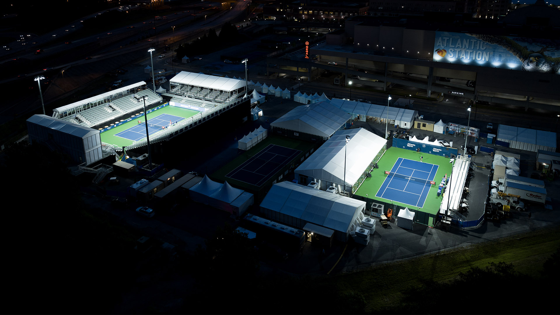 Tennis courts at the Truist Atlanta Open temporary venue lit with LED lighting from Musco Mobile.
