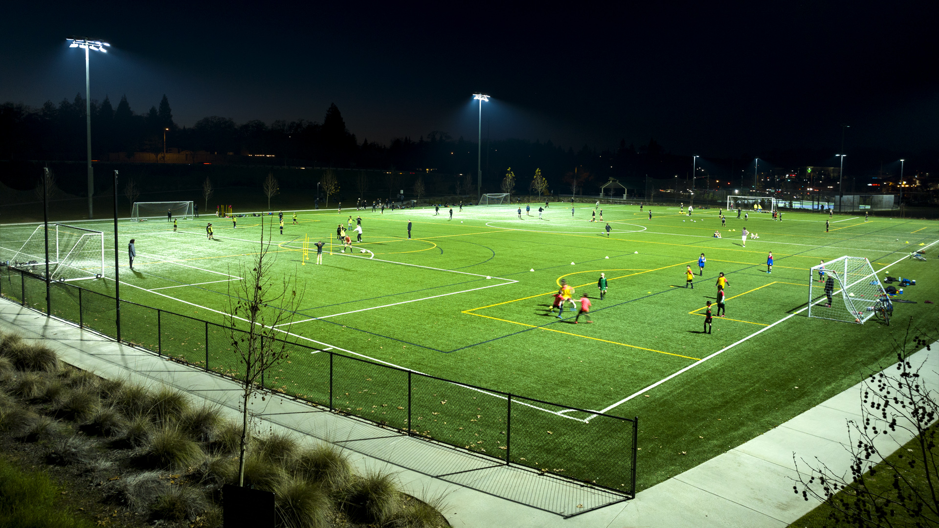Athletes practice at night at Econome Family Park after the City of Folsom updates soccer field lighting to Musco LED sports lighting.