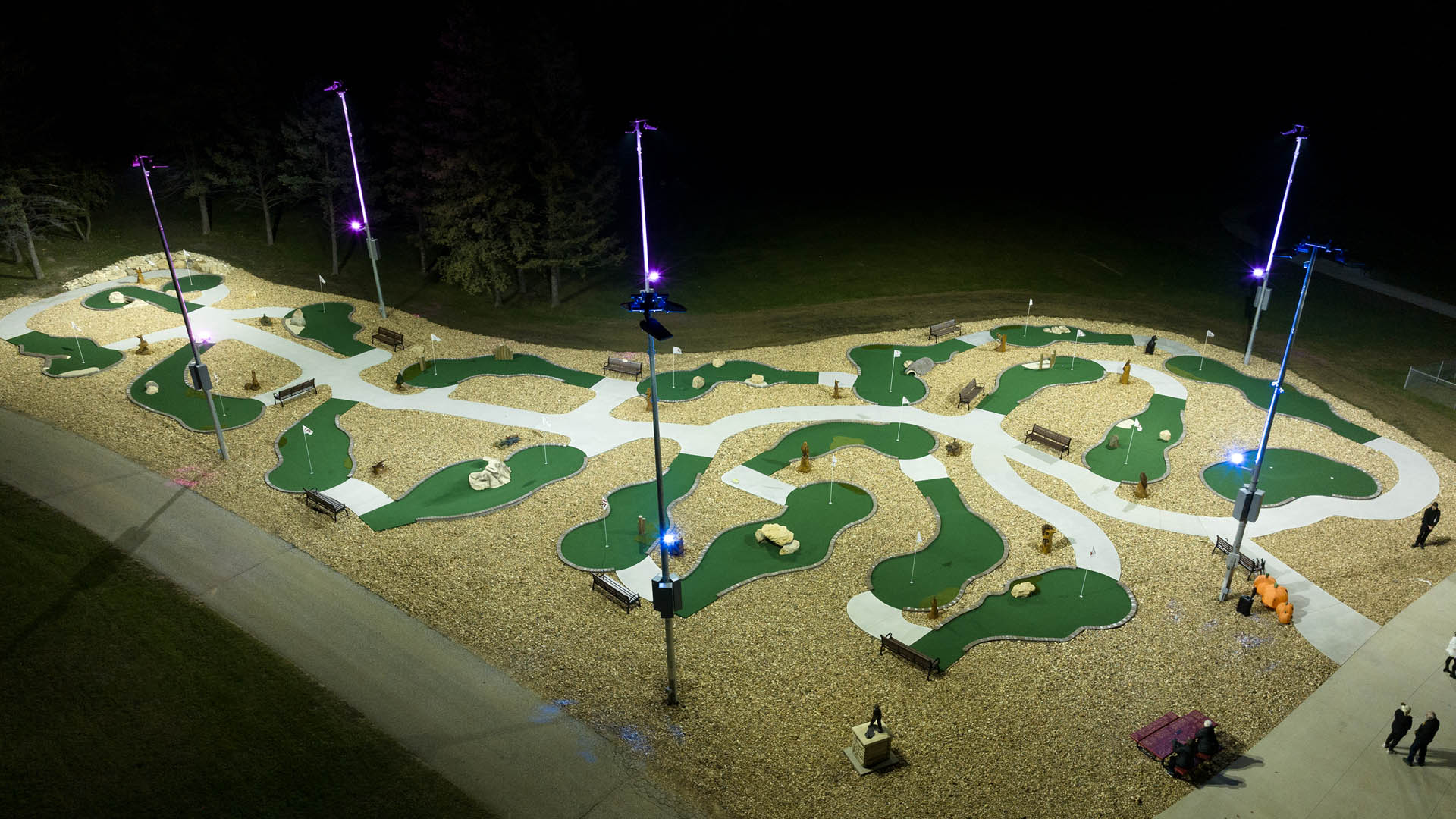 Accessible mini-golf course at Camp Courageous is lit at night with LED lights