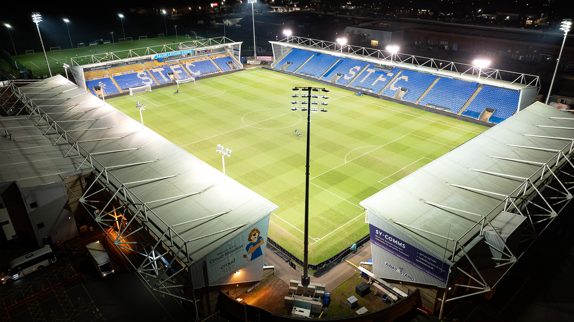 Temporary LED lighting system with Croud Meadow soccer field and blue stands in the background.