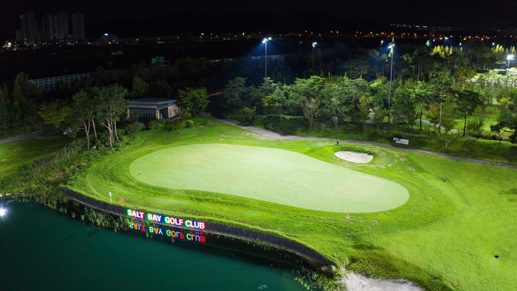 Golf green next to the water at Salt Bay Golf Club lit at night after LED upgrade.