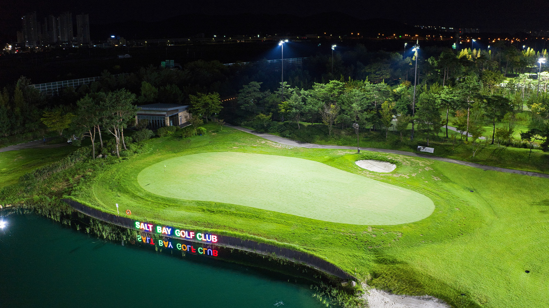 Golf green next to the water at Salt Bay Golf Club lit at night after LED upgrade.