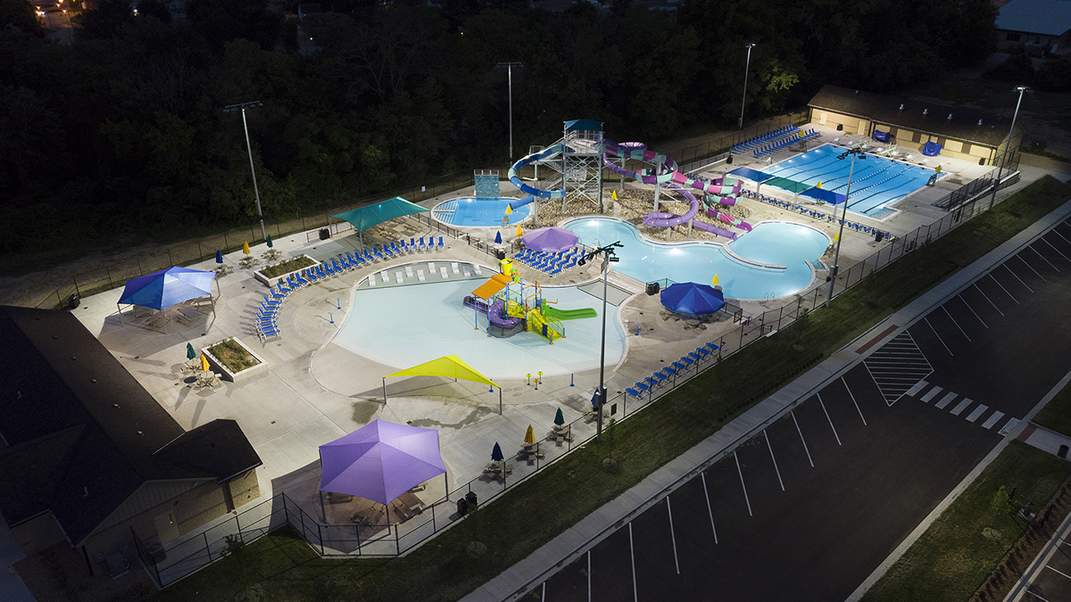 Outdoor swimming park at night with overhead lighting