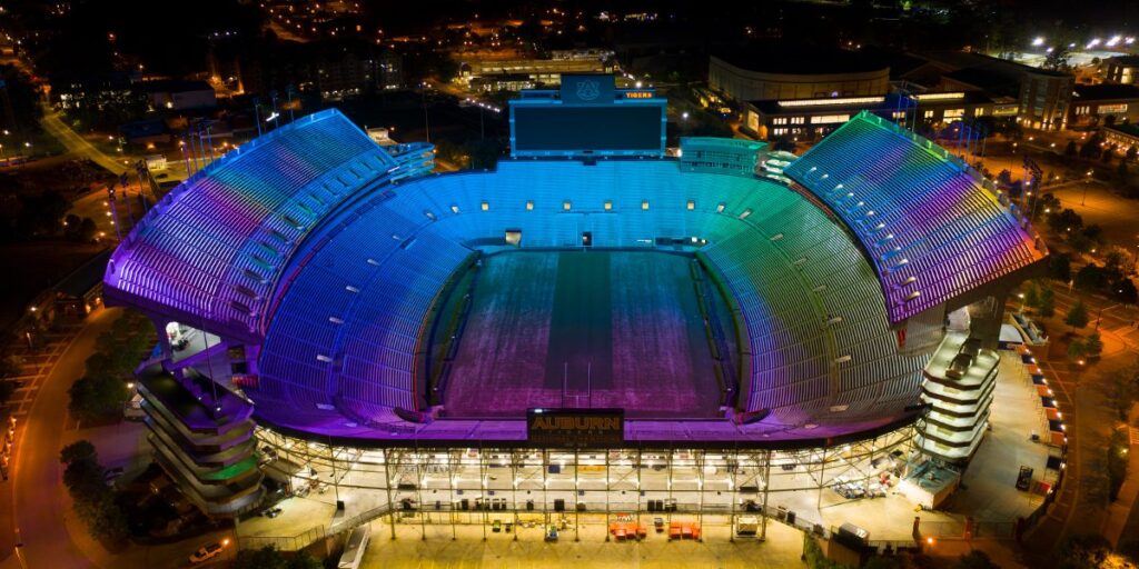 Pat Dye Field at Jordan-Hare Stadium lit with color-changing Musco TLC-RGBW technology as part of LED sports lighting upgrade.