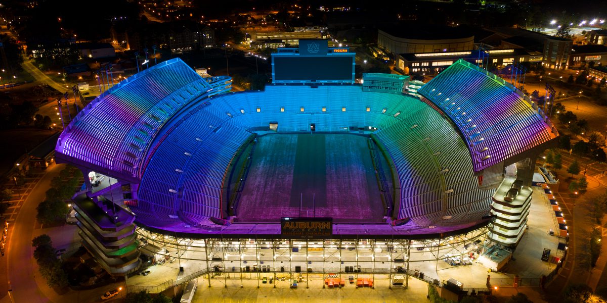 Pat Dye Field at Jordan-Hare Stadium lit with color-changing Musco TLC-RGBW technology as part of LED sports lighting upgrade.