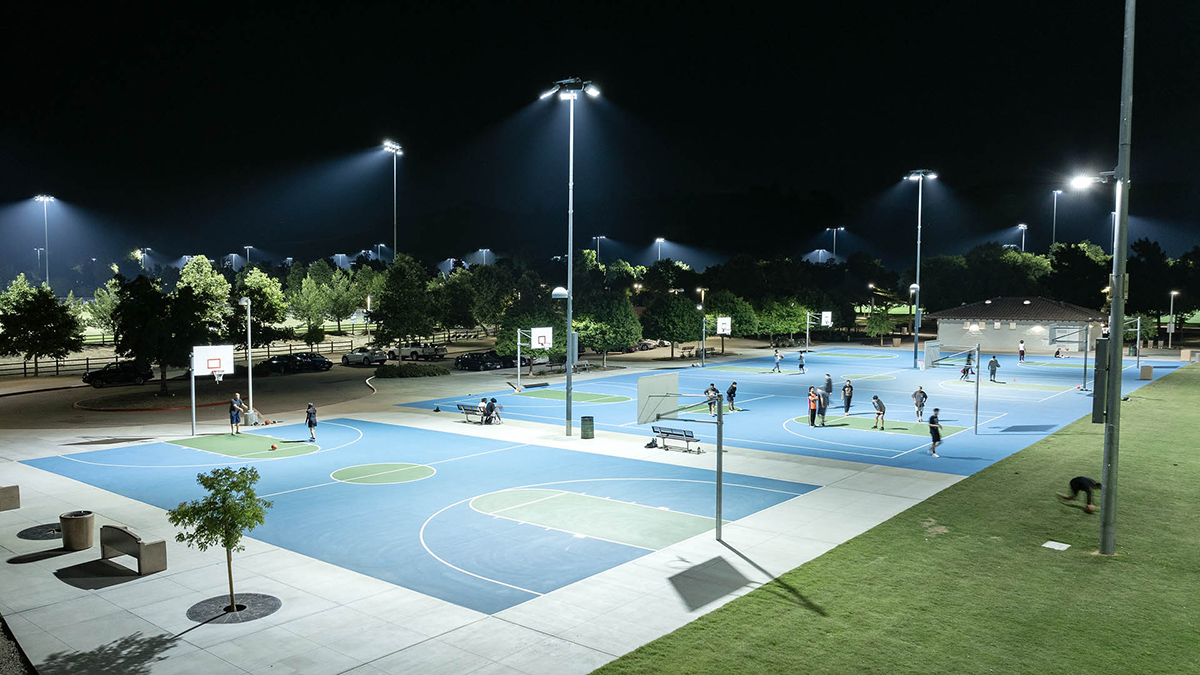 Lighted blue basketball courts at night