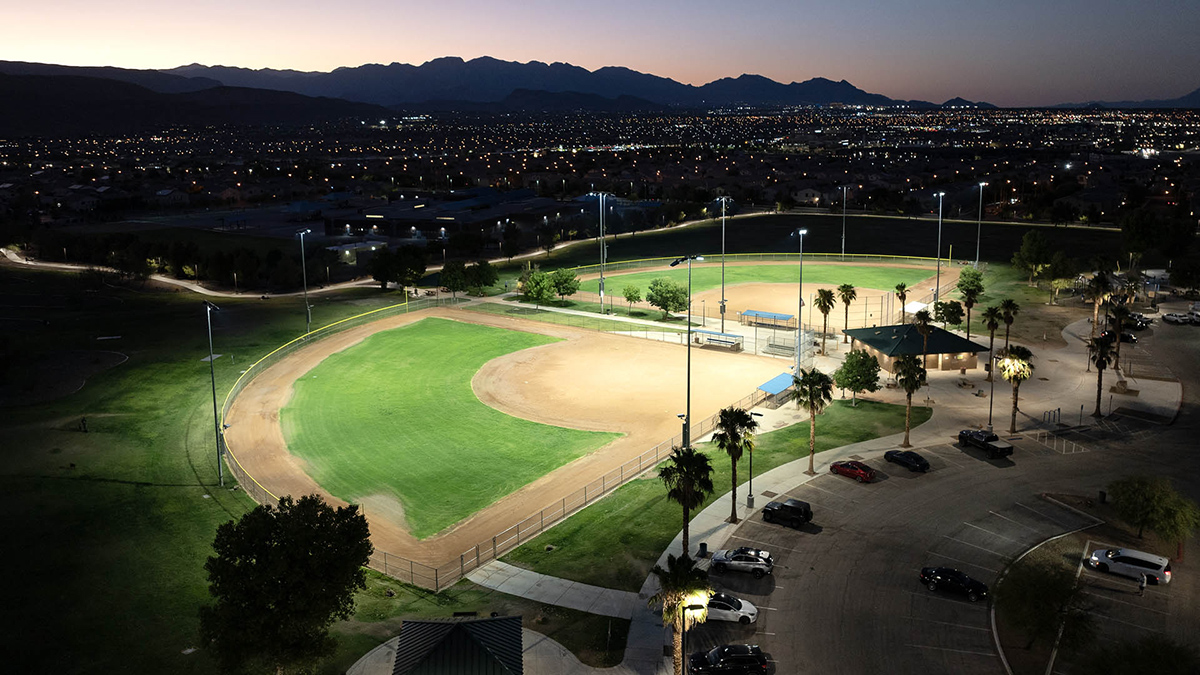 two baseball fields at night