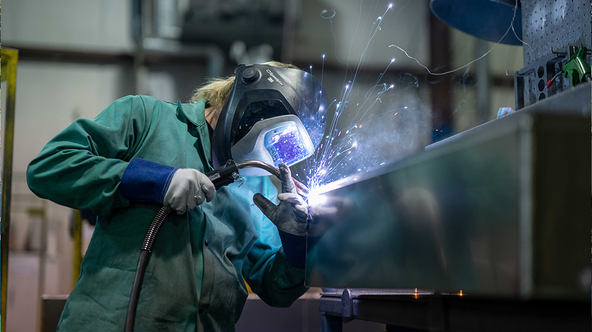 worker utilizing welding equipment