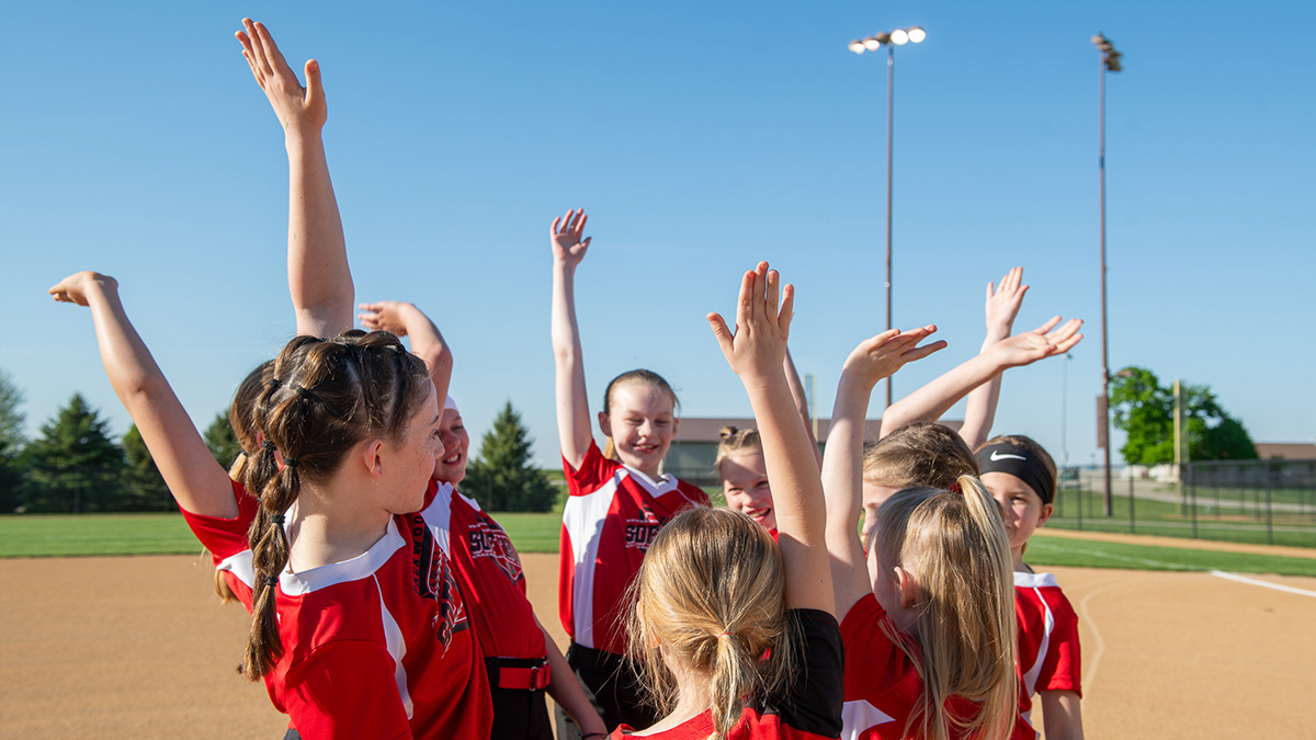girls sports team celebrating