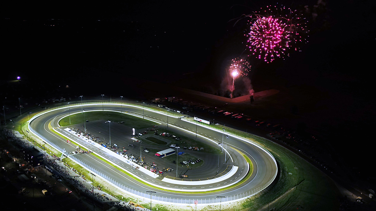 Race track with stadium lighting and fireworks going off