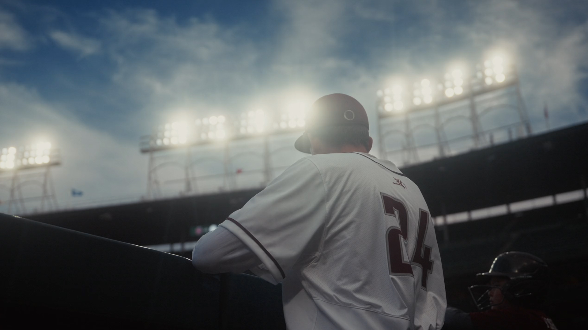 baseball player in front of stadium lights