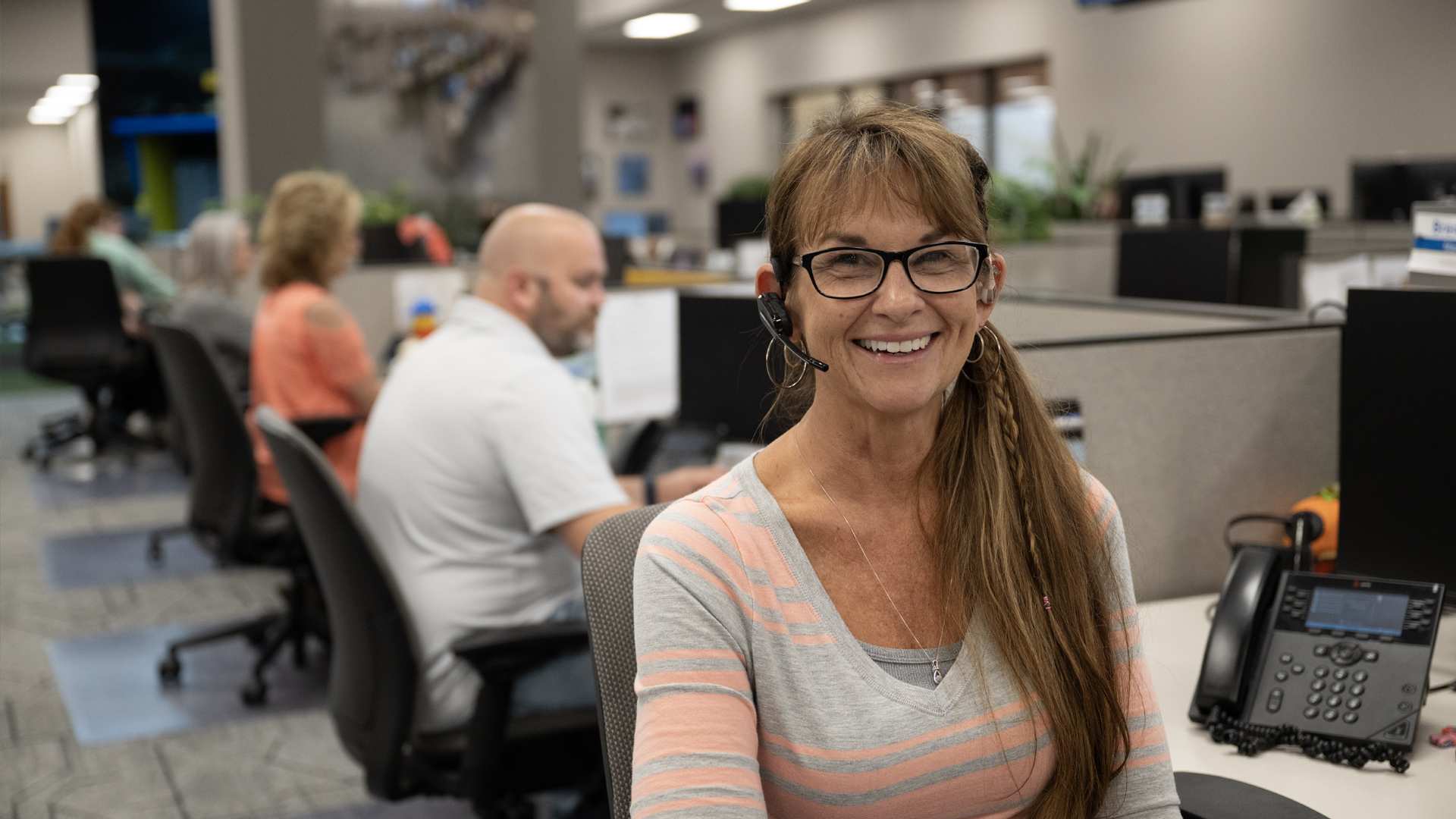Call center women with long hair with headset on