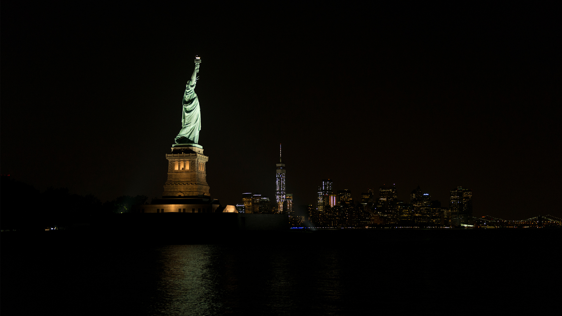 Statue of Liberty lit up at night